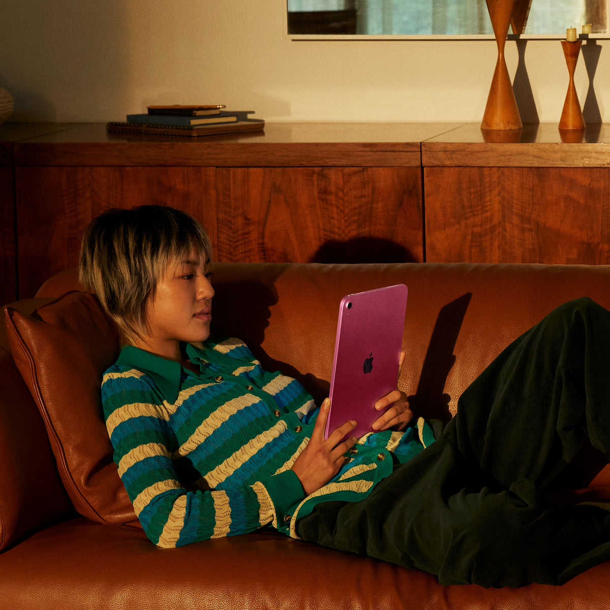 Child watching online video streams on the Apple iPad A16 Wi-Fi 128GB Pink at Tradeline.