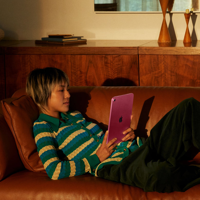 Child watching online video streams on the Apple iPad A16 Wi-Fi 128GB Pink at Tradeline.